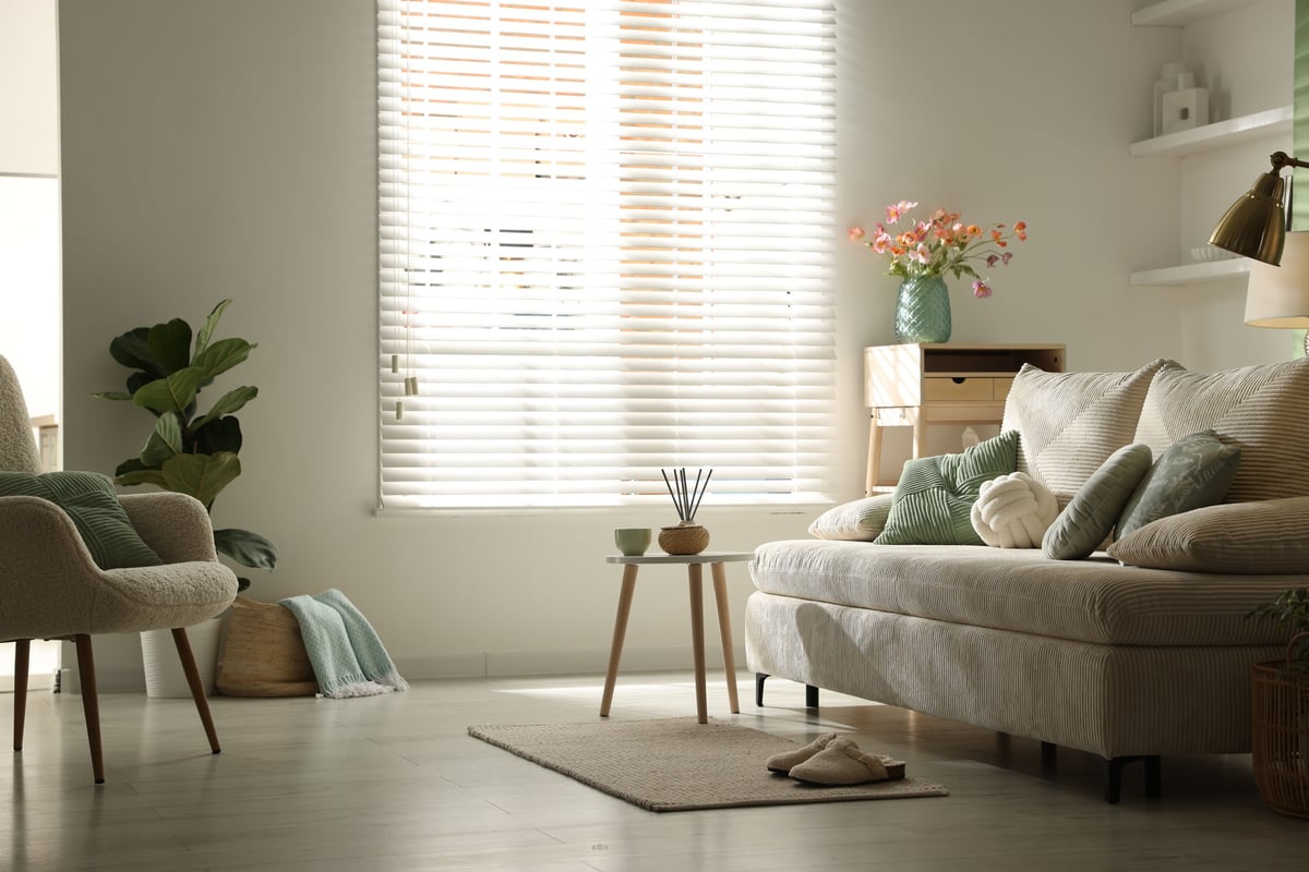 Living room with a comfortable sofa and considered decor, styled as a complete cozy set