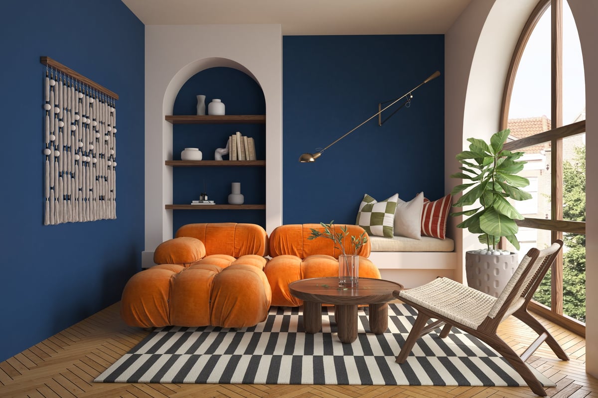 Mid-century style interior scene with bold dopamine colour cushions in mustard and rust tones